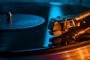 Macro closeup of turntable needle in vinyl groove with selective focus, vintage turntable, black...