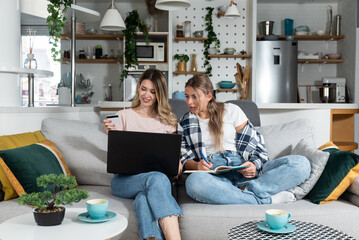Two women, roommates and business partners, jot down and steal business ideas from the internet...