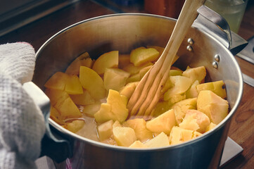 Preparation of the quince jam recipe, chopped quince and apple fruit in a pot to cook for hours...