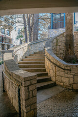 Curved staircase with stone walls at River Walk near San Antonio River, Texas
