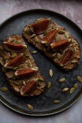 Bruschetta with peanut butter, figs and pumpkin seeds