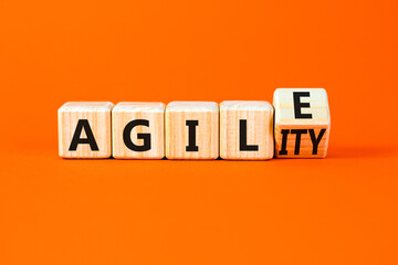 Agile and agility symbol. Concept words Agile and Agility on wooden cubes. Beautiful orange table orange background. Business agile and agility concept. Copy space.