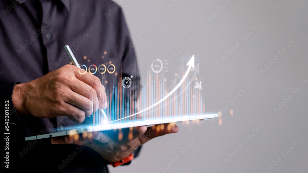 Poster people using tablets and using his finger to touch the screen with a business graph showing up in a 