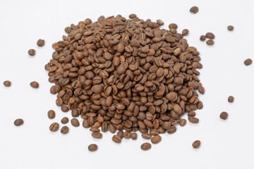 A pile of coffee beans on a white background, place for advertising.
