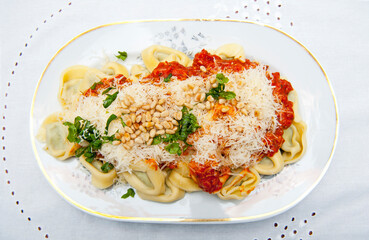 Top view of tortelloni on white porcelain plate