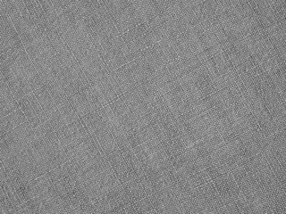 Fototapeta na wymiar Gray woven surface closeup. Linen textile texture. Fabric sewing background. Textured braided grey backdrop. Len black and white wallpaper. Macro