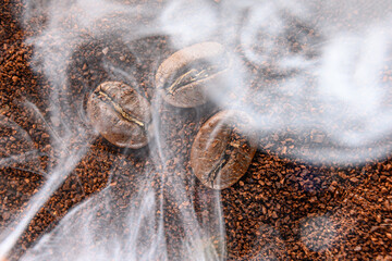 top view of coffee beans and ground coffee steaming with heat.
