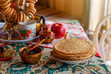 Traditional Russian food,pancakes with caviar, stand on the table with a samovar
