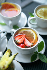 tea floating in strawberries and lemons