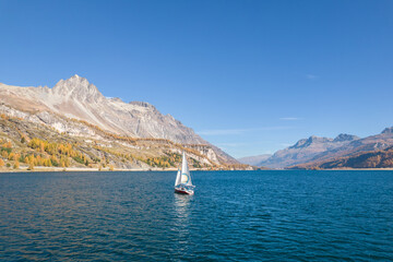 Sailing boat on the Engadine lakes. Swiss Alps.