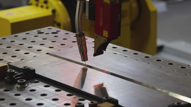 Automatic Welding Robot Process With Red Laser Beam Navigation at Work Table