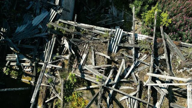 Top view of the wreckage of the old barn with the broken woods and roof in Estonia