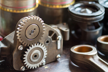 Engine oil pump with other spare parts on the metal table