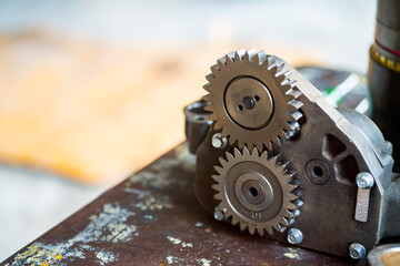 Engine oil pump with other spare parts on the metal table