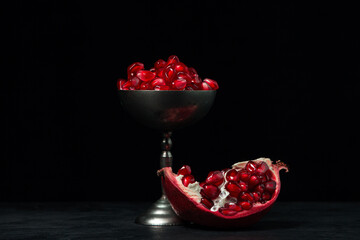 Pomegranate on a black background. Peeled pomegranate seeds - Powered by Adobe