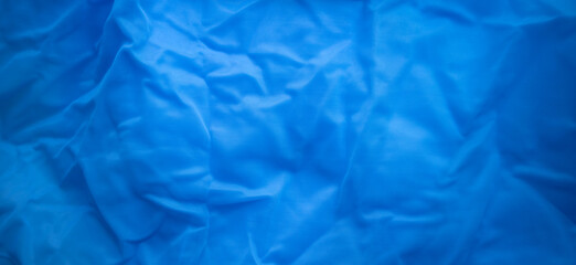 Rectangular texture of blue transparent fabric. Blue textile background. Sale of fabric for fashion...