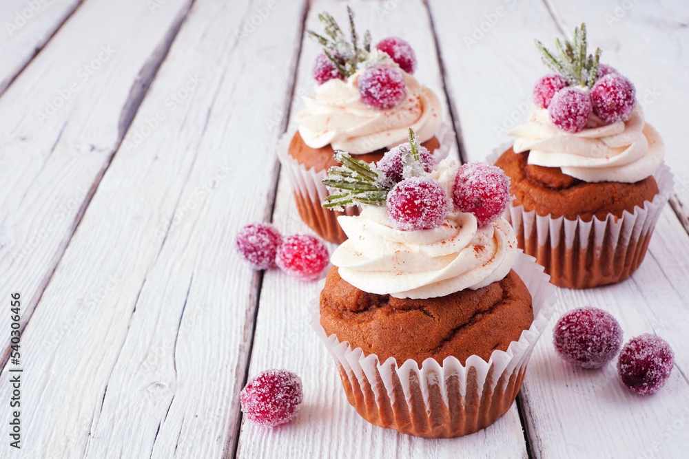 Aufkleber christmas gingerbread cupcakes with frosty cranberries. close up on a rustic white wood table backgr