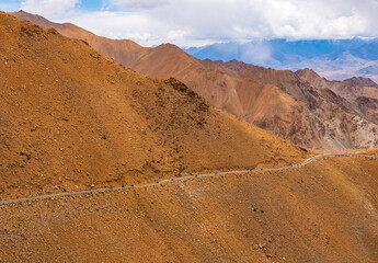 Convoy of bikers riding Mountain road of Ladakh, Northern India