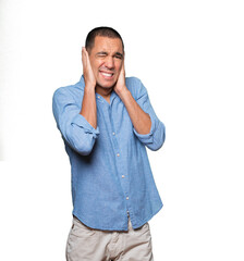 Fototapeta premium Concerned young man worried about loud noises and covering his ears