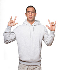 Naughty young man making a rock gesture