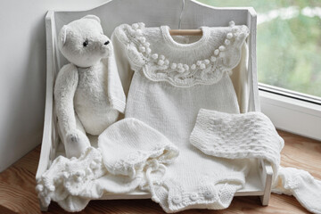 Baby knitted clothes and accessories. Baby shower party. Christening dress.