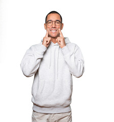 Fototapeta premium Young man pointing to his teeth