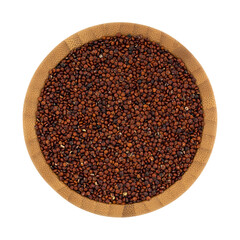 Top view of a wood bowl filled with red quinoa isolated on a white background.