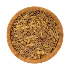Top view of rice and lentils dry food mix in a wood bamboo bowl isolated on a white background.