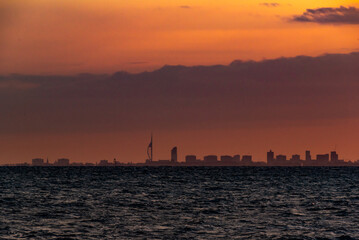 Naklejka premium Spinnaker tower Portsmouth, orange sunset over the city from Selsey UK