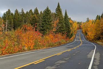 Fototapeta premium Winding road in Parc de La Mauricie through fall colors, Quebec
