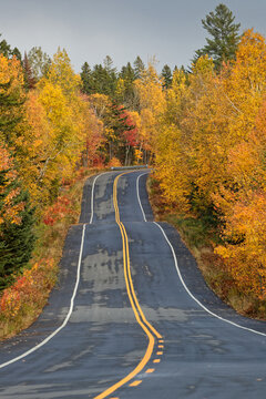 Winding road in Parc de La Mauricie through fall colors, Quebec