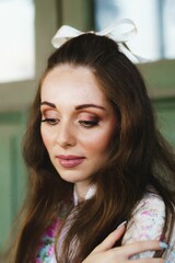 Young Caucasian girl with long hair and a ribbon bow on her head