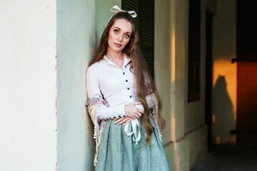 Young Caucasian girl with long hair and a ribbon bow on her head