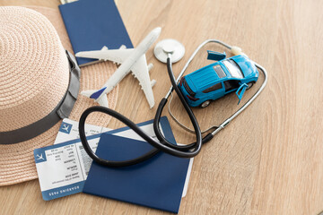 Medical Tourism, medical travel concept. Stethoscope, toy plane and passport on wooden background