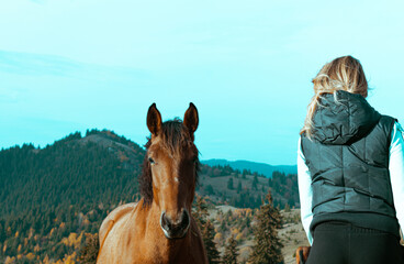 Pretty woman with  horse in autumnal nature. 