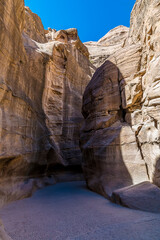 A view of the path down a narrow gorge leading to the ancient city of Petra, Jordan in summertime