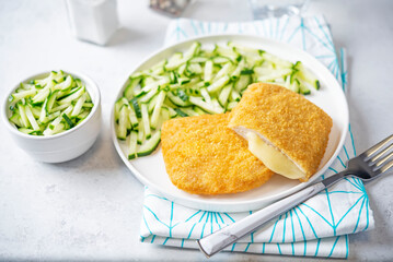 Cordon blue with cheese and cucumber salad