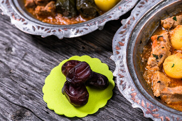 Eid Mubarak Traditional Ramadan Iftar dinner. Assorted tasty food in authentic rustic dishes on wooden blue background. Turkish Bosnian food meat kebab, pita, Sarma, klepe, sogan dolma.
