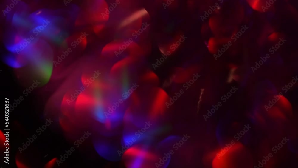 Wall mural abstract motion of purple and red bokeh with colourful reflection. purple bokeh lights abstract movi