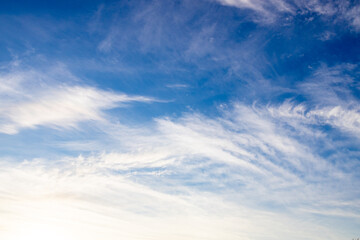 Obraz premium white clouds on a blue sky, blurry clouds lined up diagonally. cirrus clouds in the sky