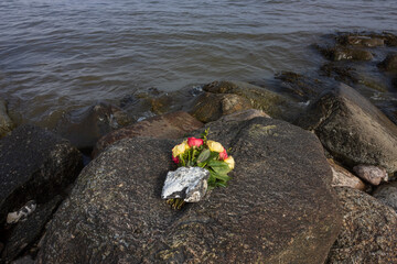 funeral flowers on  a rock, burial at sea