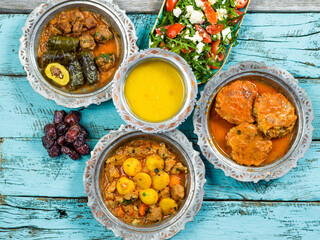 Eid Mubarak Traditional Ramadan Iftar dinner. Assorted tasty food in authentic rustic dishes on...