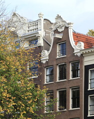 Amsterdam Herengracht Canal House Facade with Bell Gable and Autumn Foliage Close Up, Netherlands