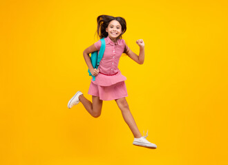 School teen girl in with backpack. Teenager student on isolated background. School leisure. Crazy run and jump. Kids learning, education, studying and knowledge.