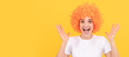 extremely happy funny girl with fancy look wearing orange hair wig on yellow background, happiness....