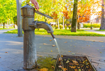 Pumping water from the park hand pump well