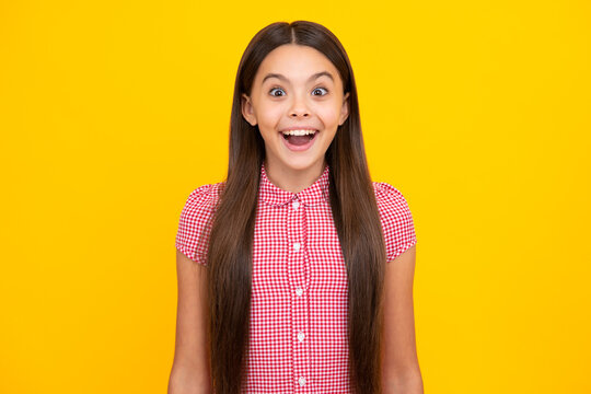 Excited Teenager Girl Opening Mouth In Excitement, Believe Big Sale Or Promo On Yellow Studio Background, Copy Space. Amazed Teen Girl. Excited Expression, Cheerful And Glad.