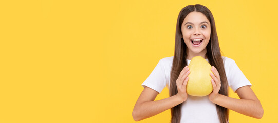 happy kid girl hold big citrus fruit of yellow pummelo or pomelo full of vitamin. Child girl...