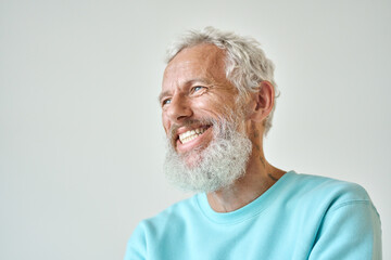 Smiling bearded mature older fashion gray-haired hipster man, happy old senior male model having fun feeling cheerful looking away laughing standing isolated at white wall. Close up headshot - obrazy, fototapety, plakaty
