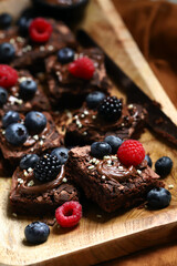 Macro. Brownie cakes with berries and chocolate on top. Delicious chocolate dessert.